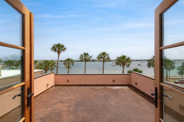 unfurnished sunroom with a water view