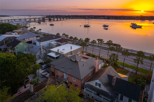 aerial view at dusk with a water view