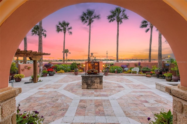 patio terrace at dusk with a pergola