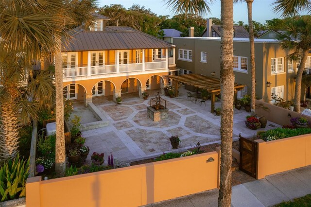 back of property with a patio and a balcony