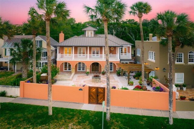 view of front of house featuring a pergola, a patio, and a balcony