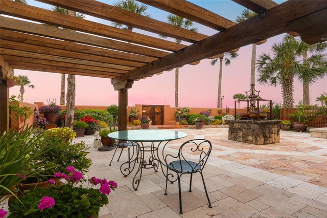 patio terrace at dusk with a pergola