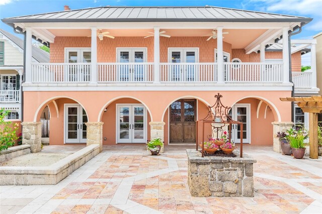 back of house featuring french doors, a balcony, ceiling fan, and a patio area