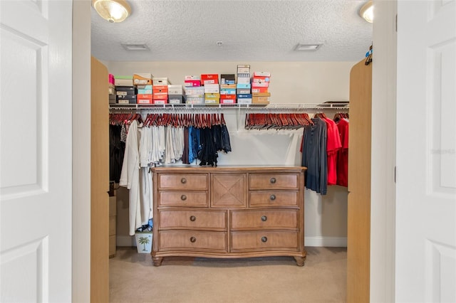 spacious closet featuring light carpet