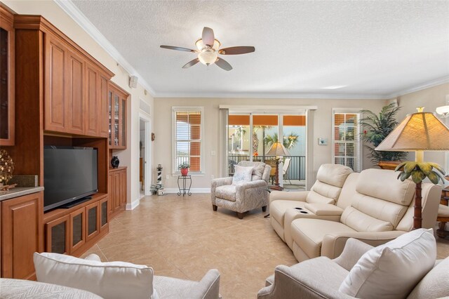 living room with ceiling fan, ornamental molding, and a textured ceiling