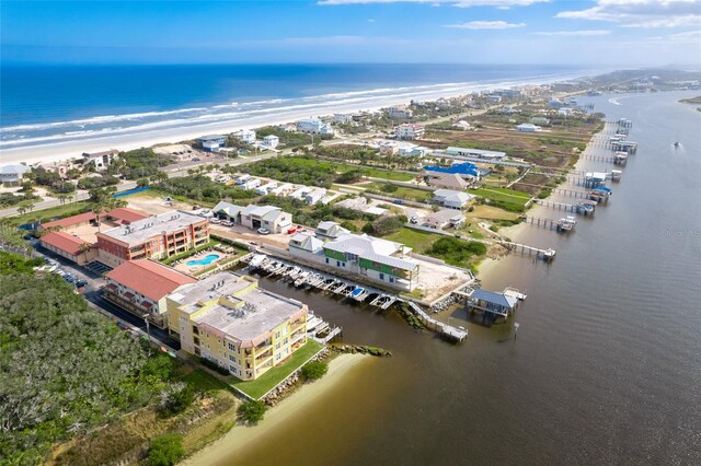 drone / aerial view featuring a water view and a view of the beach