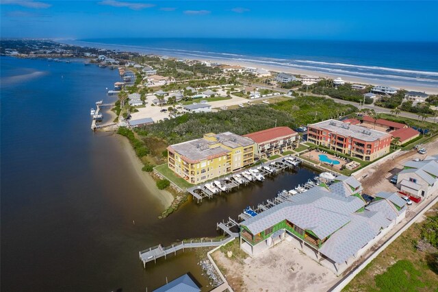 drone / aerial view featuring a water view and a beach view