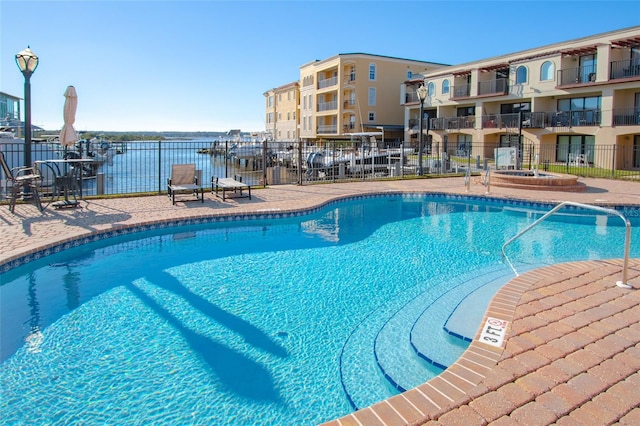 view of swimming pool with a water view