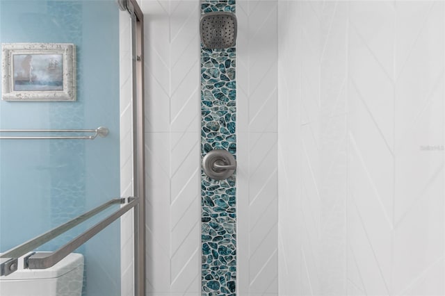 bathroom with tiled shower