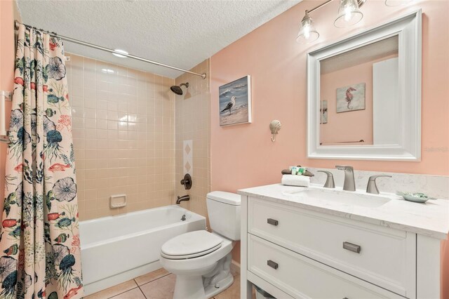 full bathroom featuring toilet, shower / bath combination with curtain, tile patterned floors, a textured ceiling, and vanity