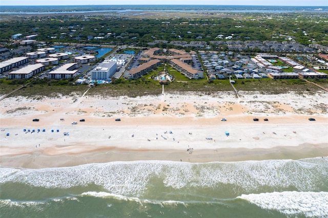 bird's eye view with a water view and a beach view