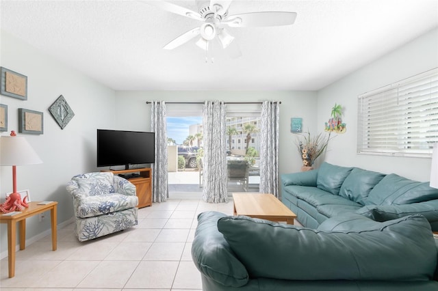 tiled living room with ceiling fan and a textured ceiling