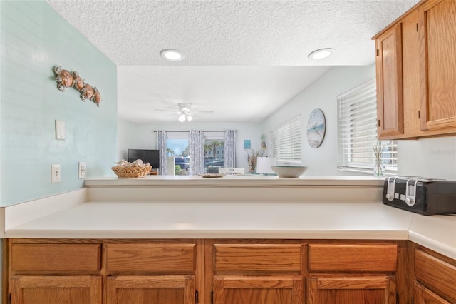 kitchen featuring ceiling fan and a textured ceiling