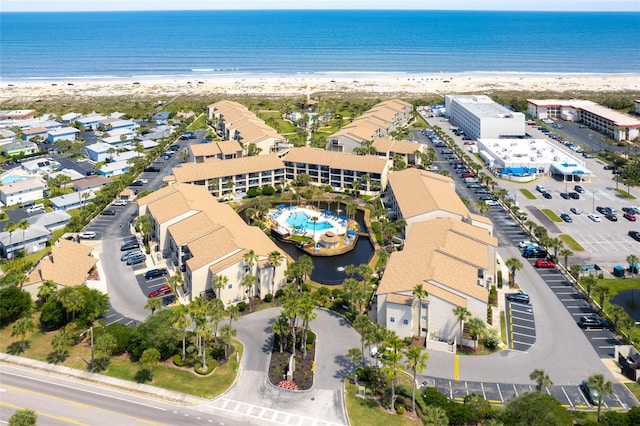 birds eye view of property featuring a water view and a view of the beach