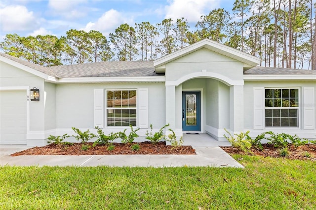 66 Ryland Dr, Palm Coast, FL 32164 - doorway to property with a yard and a garage