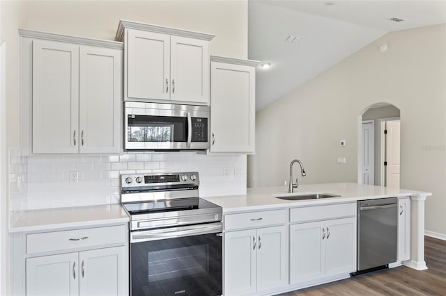 66 Ryland Dr, Palm Coast, FL 32164 - kitchen featuring white cabinets, backsplash, sink, and appliances with stainless steel finishes