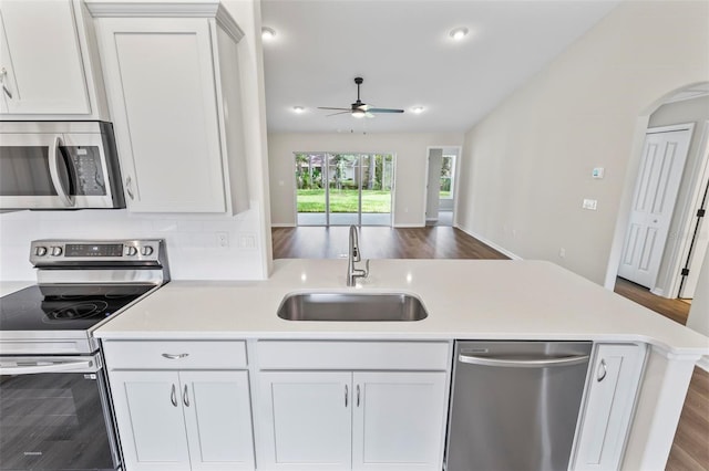 66 Ryland Dr, Palm Coast, FL 32164 - kitchen featuring ceiling fan, sink, white cabinets, and stainless steel appliances