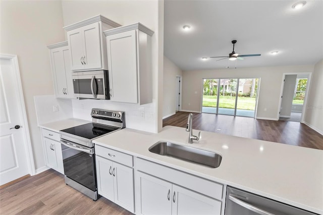 66 Ryland Dr, Palm Coast, FL 32164 - kitchen with white cabinets, stainless steel appliances, light hardwood / wood-style flooring, and sink