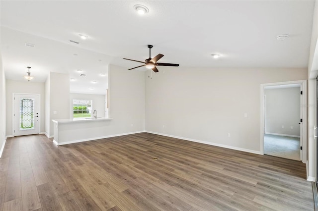 66 Ryland Dr, Palm Coast, FL 32164 - unfurnished living room with ceiling fan, sink, wood-type flooring, and lofted ceiling