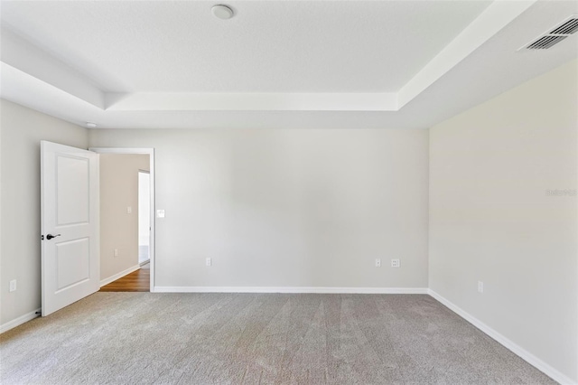 66 Ryland Dr, Palm Coast, FL 32164 - spare room with a raised ceiling and light colored carpet