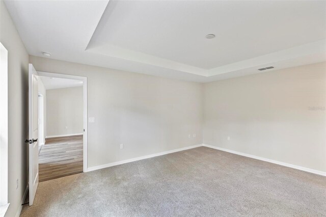 66 Ryland Dr, Palm Coast, FL 32164 - empty room featuring carpet flooring and a tray ceiling