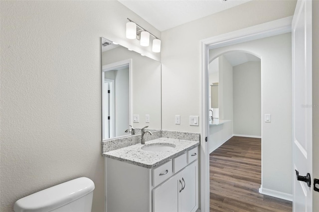 66 Ryland Dr, Palm Coast, FL 32164 - bathroom featuring hardwood / wood-style flooring, vanity, and toilet