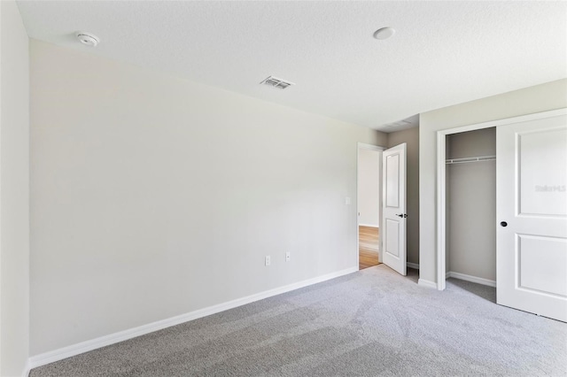 66 Ryland Dr, Palm Coast, FL 32164 - unfurnished bedroom featuring carpet flooring, a closet, and a textured ceiling