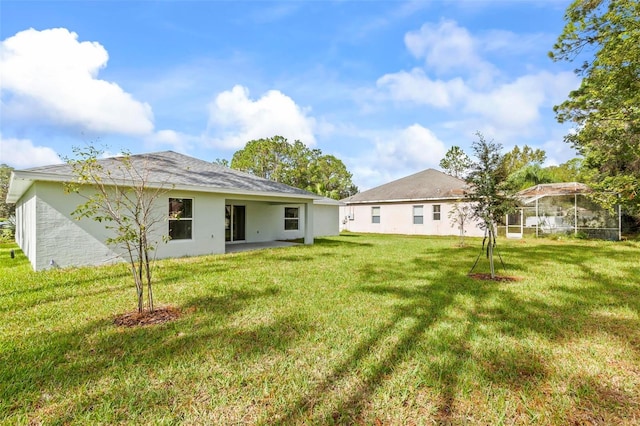 66 Ryland Dr, Palm Coast, FL 32164 - back of house featuring a lawn