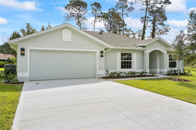 ranch-style home featuring a front lawn and a garage