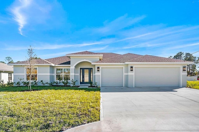 view of front of house with a front lawn and a garage