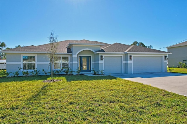 view of front facade with a front lawn and a garage