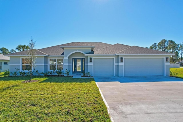 ranch-style home featuring a front lawn and a garage