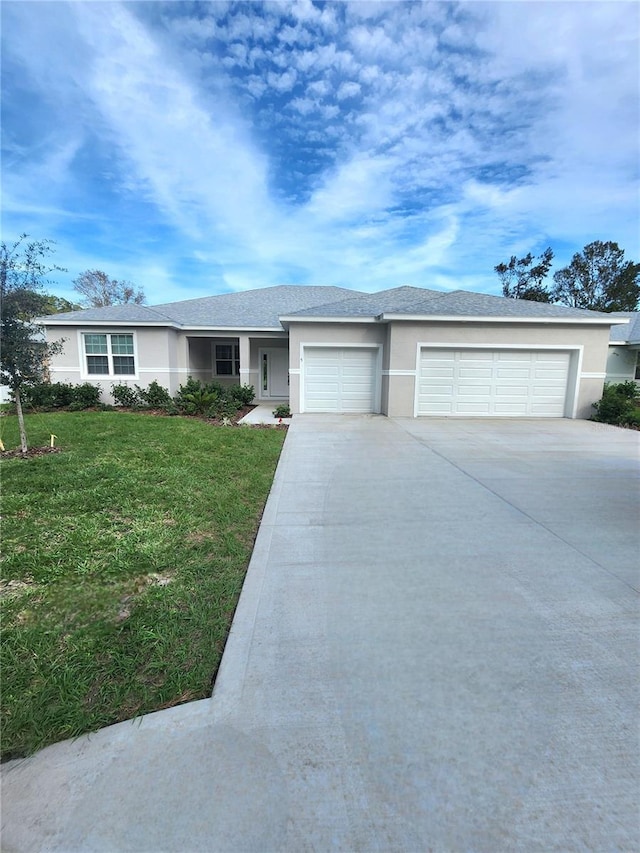 view of front facade featuring a front yard and a garage