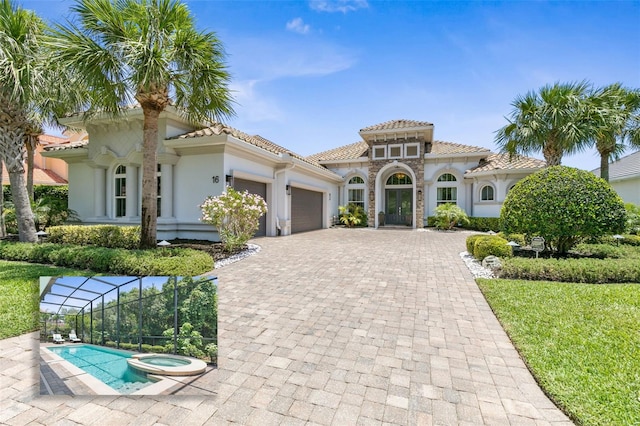 mediterranean / spanish-style house featuring a garage, an in ground hot tub, and a lanai