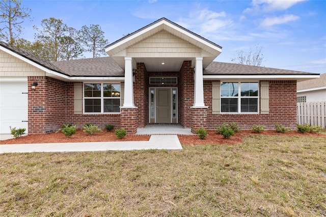 view of front of home featuring a front lawn and a garage