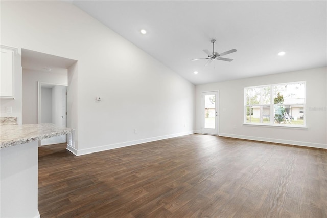 unfurnished living room featuring ceiling fan, dark hardwood / wood-style flooring, and lofted ceiling