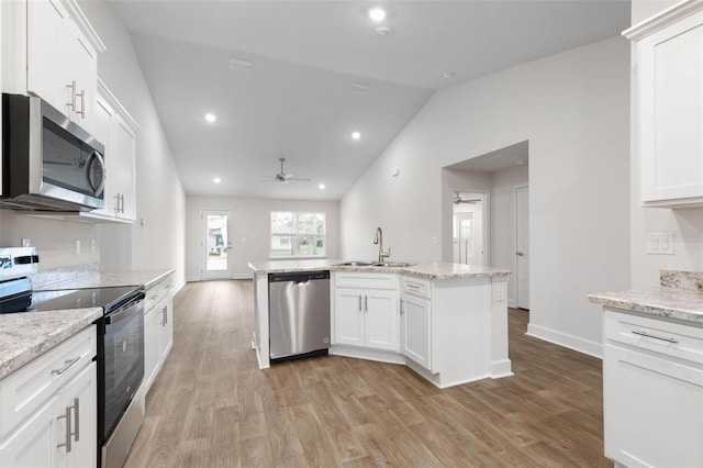 kitchen with ceiling fan, white cabinets, appliances with stainless steel finishes, and sink