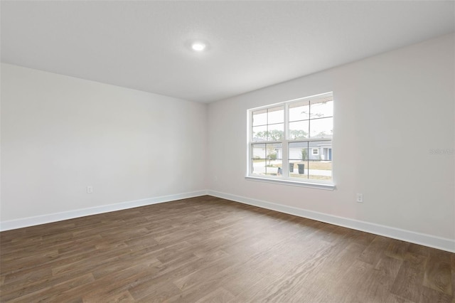 unfurnished room featuring dark hardwood / wood-style floors