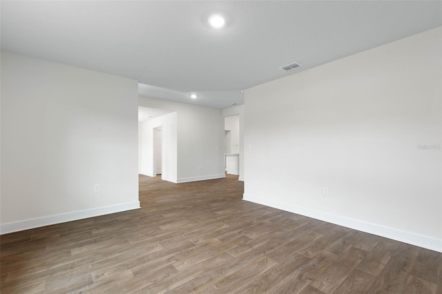 empty room with hardwood / wood-style floors