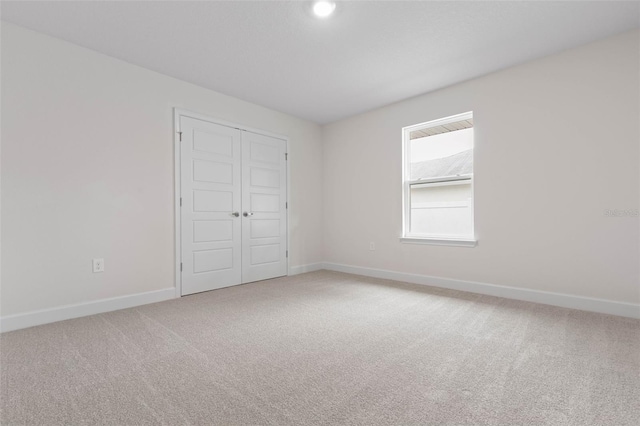 unfurnished bedroom featuring carpet floors and a closet