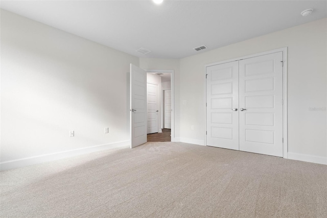 unfurnished bedroom with a closet and carpet flooring