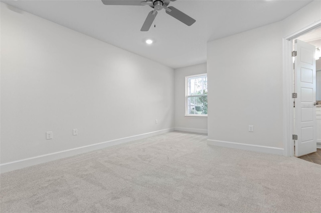 carpeted spare room featuring a ceiling fan, baseboards, and recessed lighting
