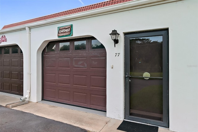 view of exterior entry with a garage