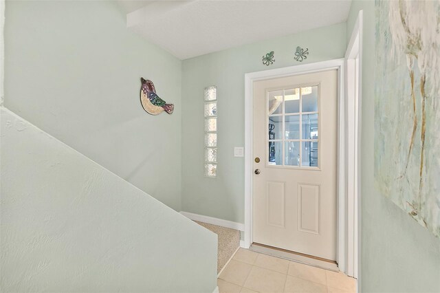 entryway with light tile patterned flooring