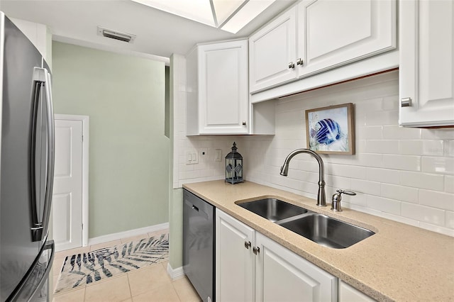 kitchen with stainless steel appliances, sink, and white cabinets