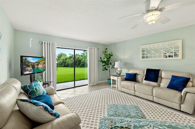 tiled living room featuring ceiling fan and a textured ceiling