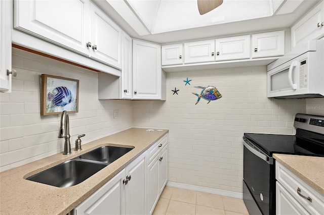 kitchen with sink, light tile patterned floors, ceiling fan, white cabinets, and stainless steel electric stove