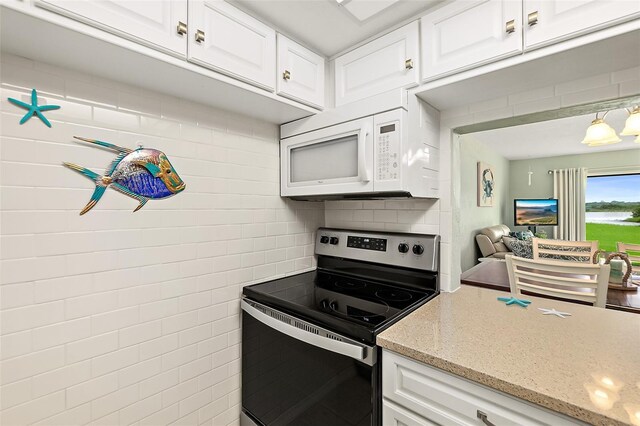 kitchen featuring white cabinetry, stainless steel electric range oven, light stone counters, and backsplash