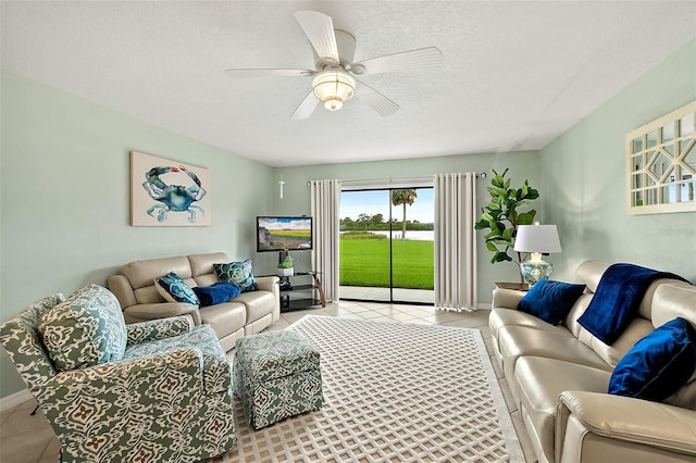 tiled living room with ceiling fan and a textured ceiling