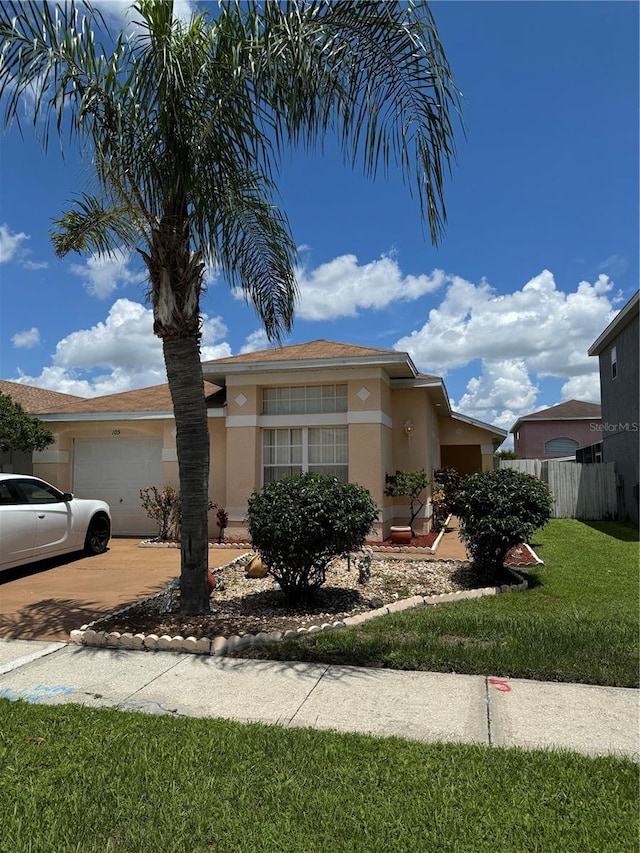 view of front of property with a garage and a front yard